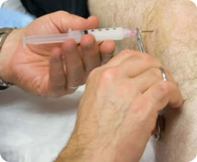 Healthcare professional administering a joint injection to a patient for pain relief in New York City
