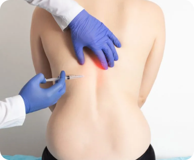 Healthcare professional administering a spinal injection to a patient's lower back for pain relief in New York City